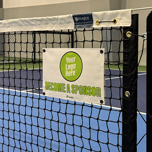 Pickleball net banner with 'Your Logo Here' sponsor placeholder snapped onto an indoor court net