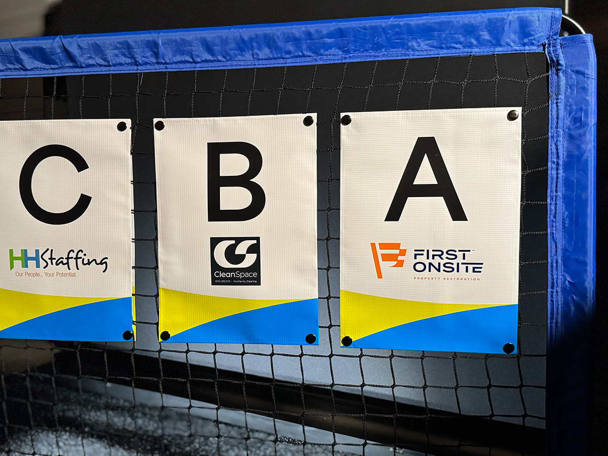 Multi-sponsor NetSnapz banners displayed across a full volleyball tournament setup