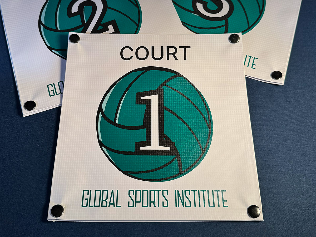 Global Sports Institute court ID snap-on banners at a multi-court volleyball event