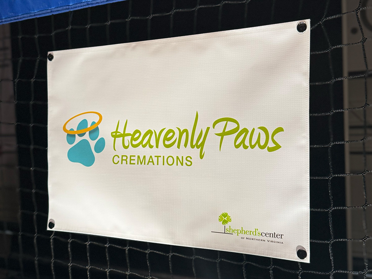 Custom logo pickleball net sign snapped onto court net